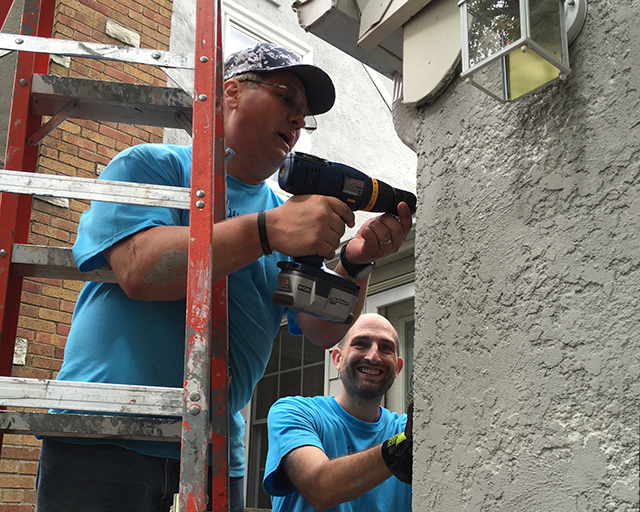 Volunteers working on the exterior a home