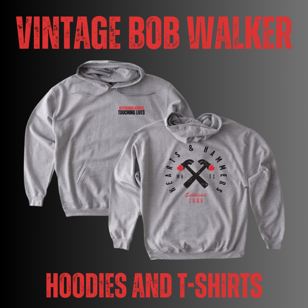 Two gray hoodies from the Vintage Bob Walker collection are displayed against a black and gray gradient background. One hoodie features the phrase 'Restoring Homes. Touching Lives.' on the front, while the other showcases the Hearts & Hammers logo with crossed hammers, 'MN' and 'TX' state abbreviations, and 'Established 1986' in red text. Bold red distressed text at the top reads 'VINTAGE BOB WALKER,' and at the bottom, 'HOODIES AND T-SHIRTS.'