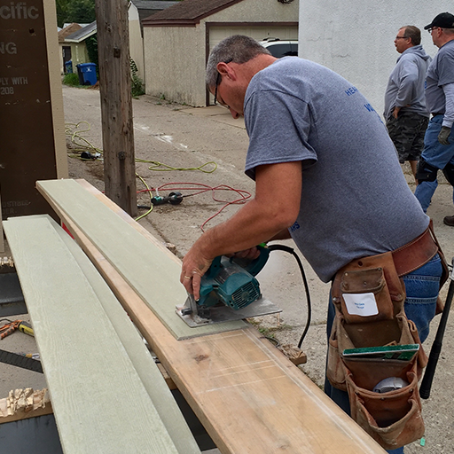 Planks of wood being sawn outside