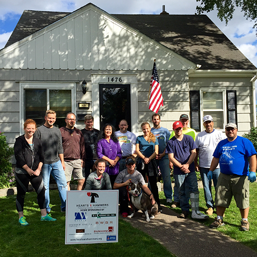 Hearts & Hammers volunteers in front of a home